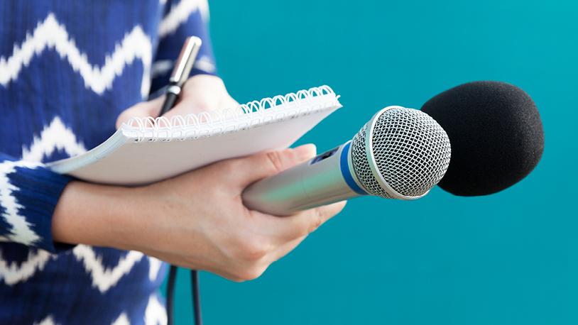 student holding a microphone