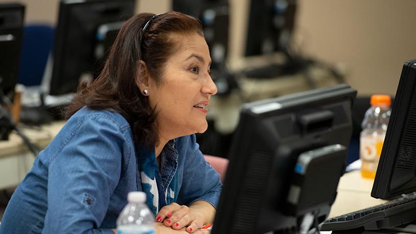 A female Hispanic adult MCC student in a classroom